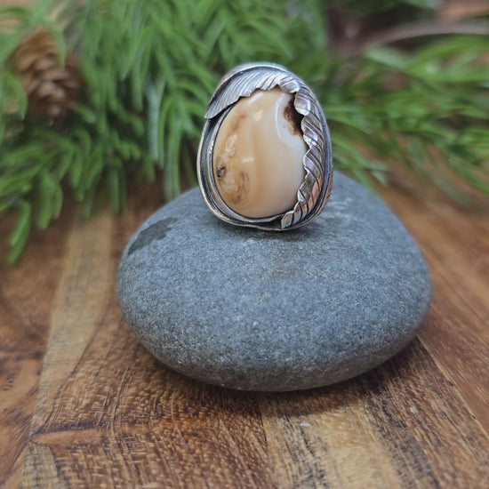 video of sterling silver elk ivory feather-wrapped ring being rotated by hand