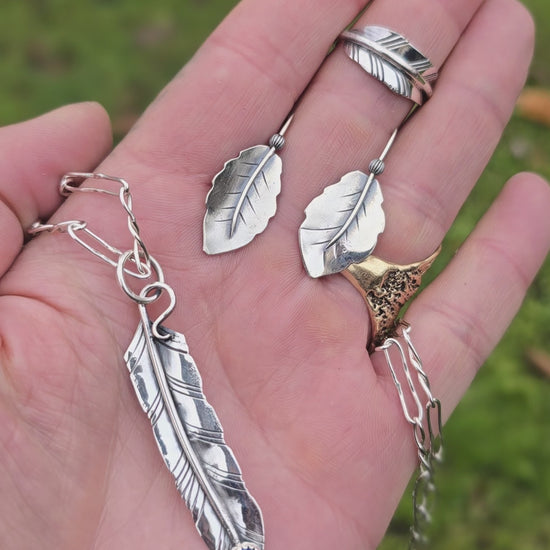 video showing feather pendant with oil Czech glass, leaf ring, and leaf threader earrings displayed together
