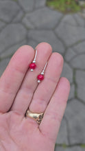 Load and play video in Gallery viewer, faceted red agate and sterling earrings rotated on a hand
