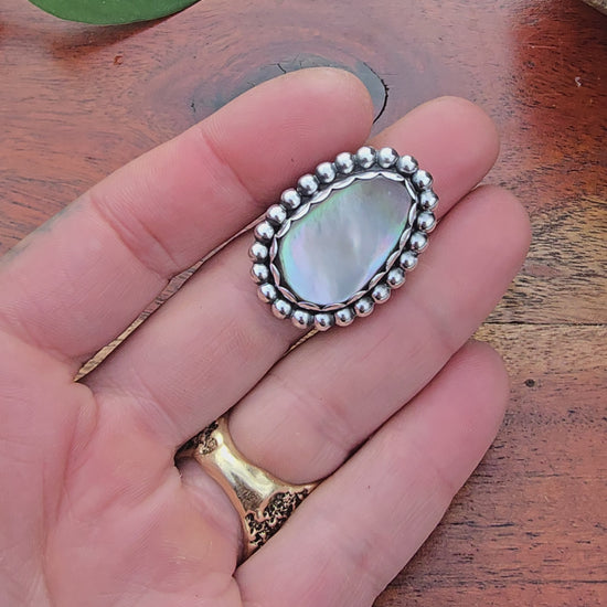 video showing mother of pearl ring with big beaded bezel being rotated for display