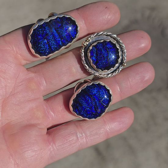 Handcrafted sterling silver rings featuring shimmering blue dichroic glass and double ring shanks