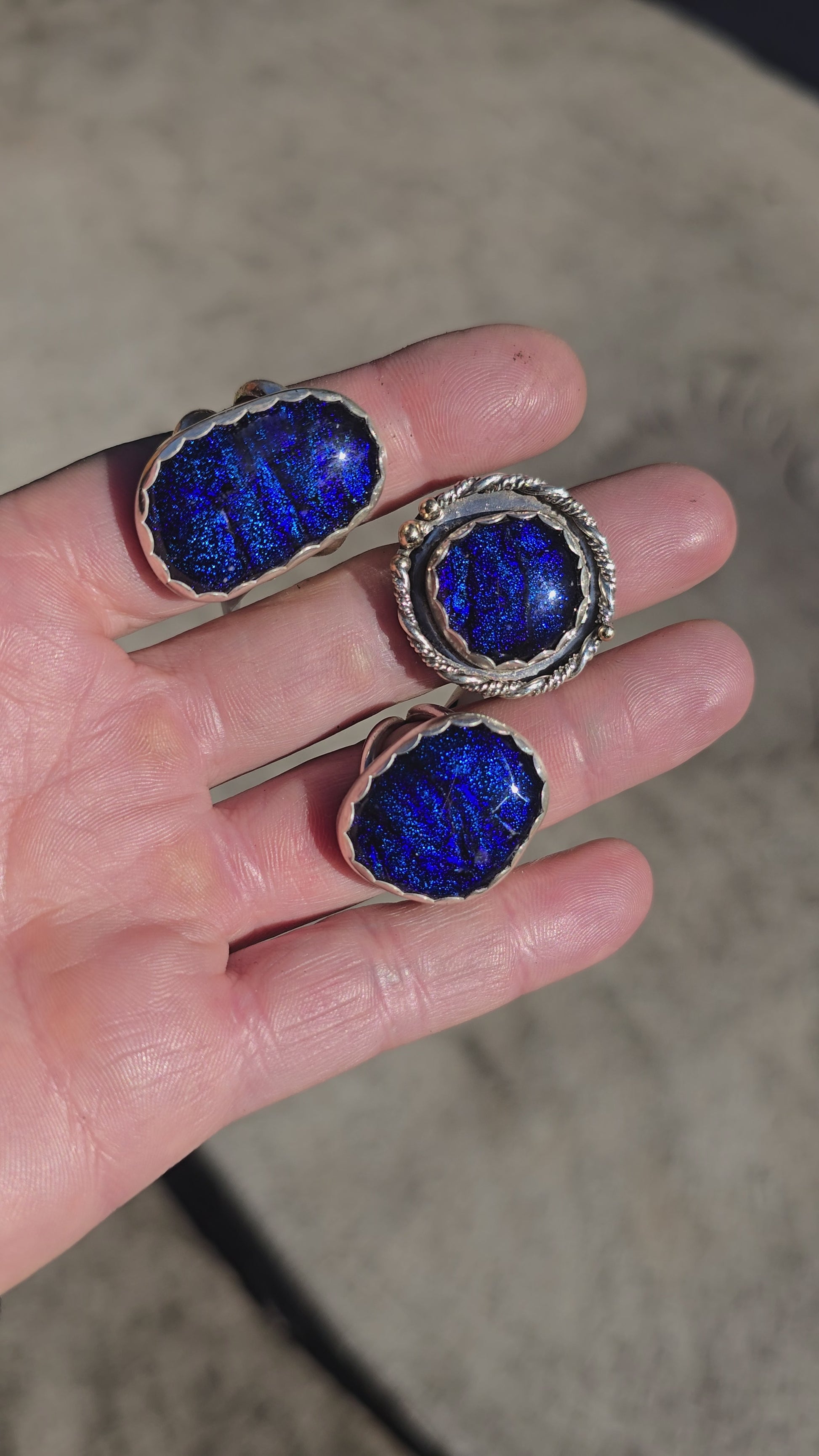 Handcrafted sterling silver rings featuring shimmering blue dichroic glass and double ring shanks