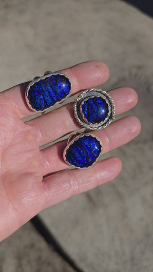 Handcrafted sterling silver rings featuring shimmering blue dichroic glass and double ring shanks