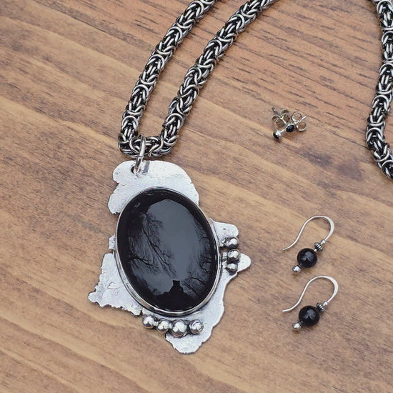 video of black onyx pendant, threader earrings, and post earrings being rotated for display