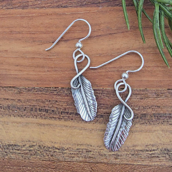 styled display of 1.5 inch sterling silver feather earrings