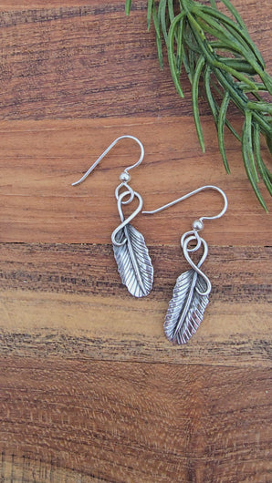 styled display of 1.5 inch sterling silver feather earrings