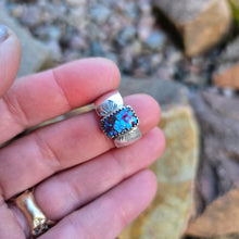 Load image into Gallery viewer, top view of purple Mohave turquoise ring with textured sterling silver band on hand
