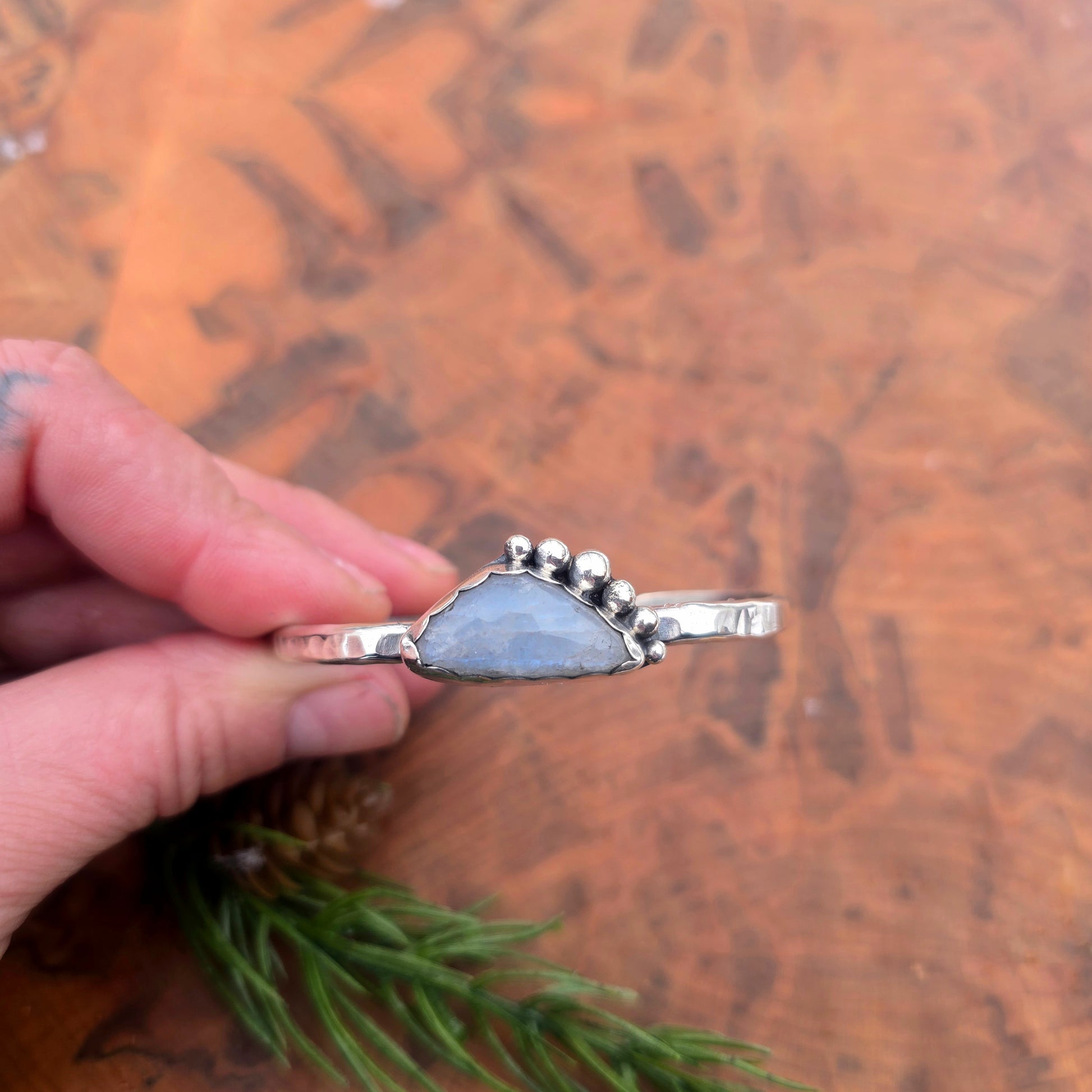 Detail of rainbow moonstone and silver bead accents on cuff