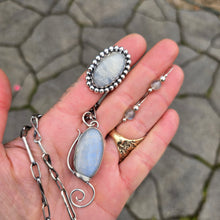 Load image into Gallery viewer, Full Rainbow Moonstone jewelry collection featuring threader earrings, a windswept pendant, a beaded moonstone ring, and a handmade twisted link chain displayed on hand
