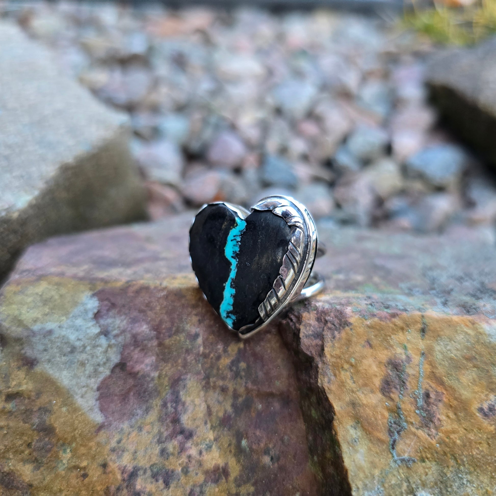 front view of royston ribbon turquoise heart ring with feather wrap design