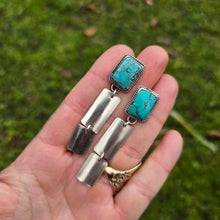 Load image into Gallery viewer, pair of royston turquoise dangle earrings shown on hand for display
