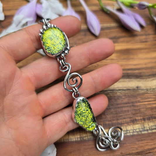Sterling silver swirl bracelet with yellow stones on hand