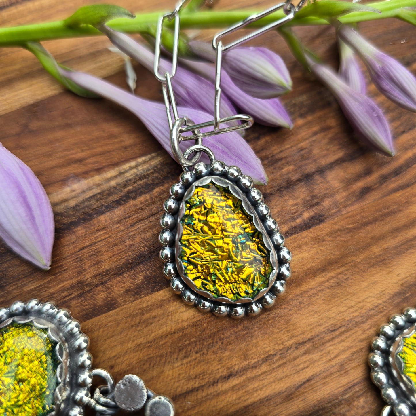 Beaded sterling silver and yellow dichroic pendant top view