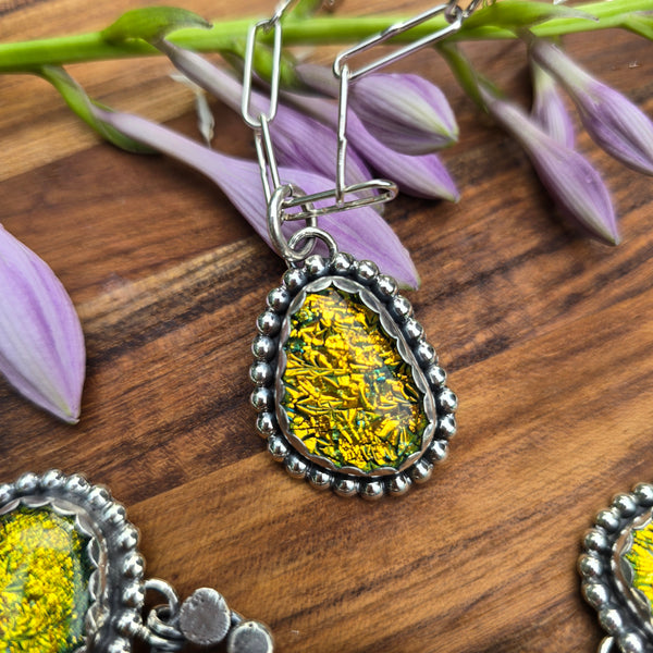 Beaded sterling silver and yellow dichroic pendant top view