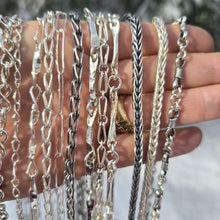Load image into Gallery viewer, sterling silver collection of shiny and oxidized chains shown on hand front view
