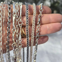 Load image into Gallery viewer, sterling silver shiny and oxidized chains shown close up on hand
