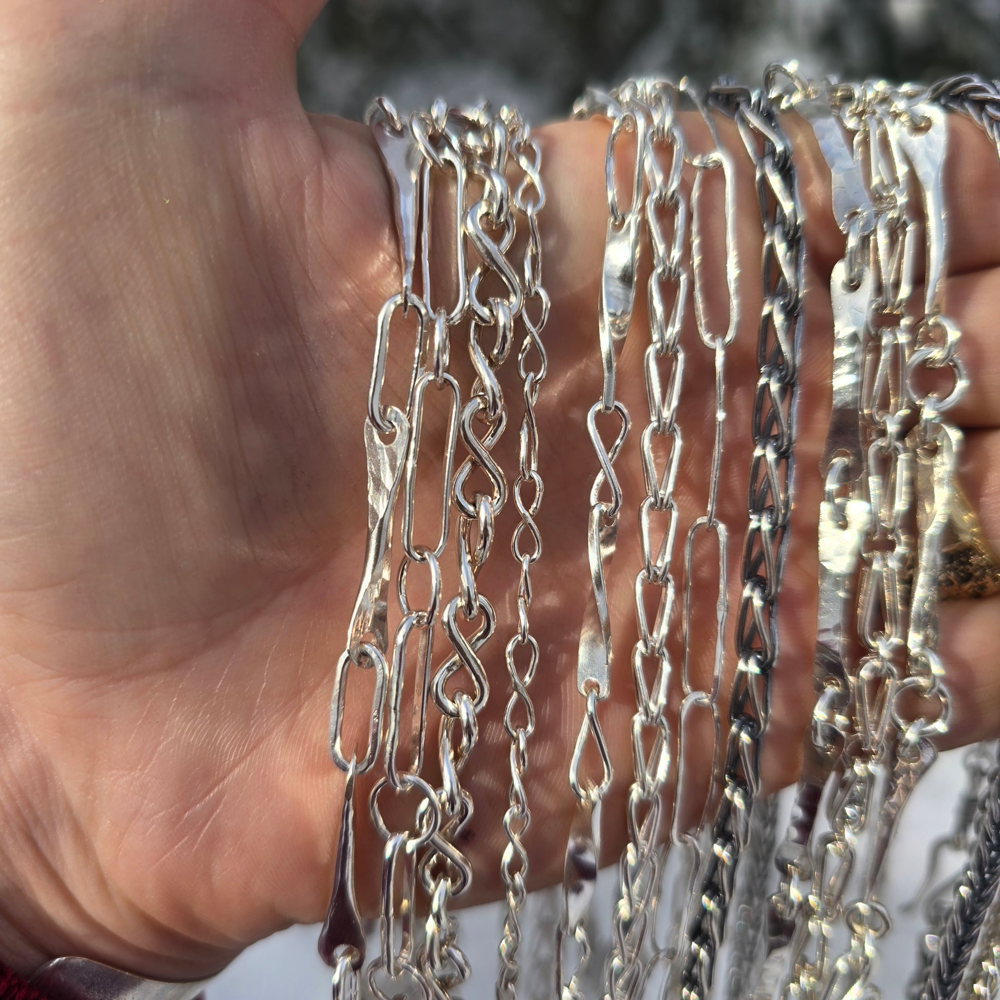 sterling silver shiny and oxidized chains shown in detail from front view on hand