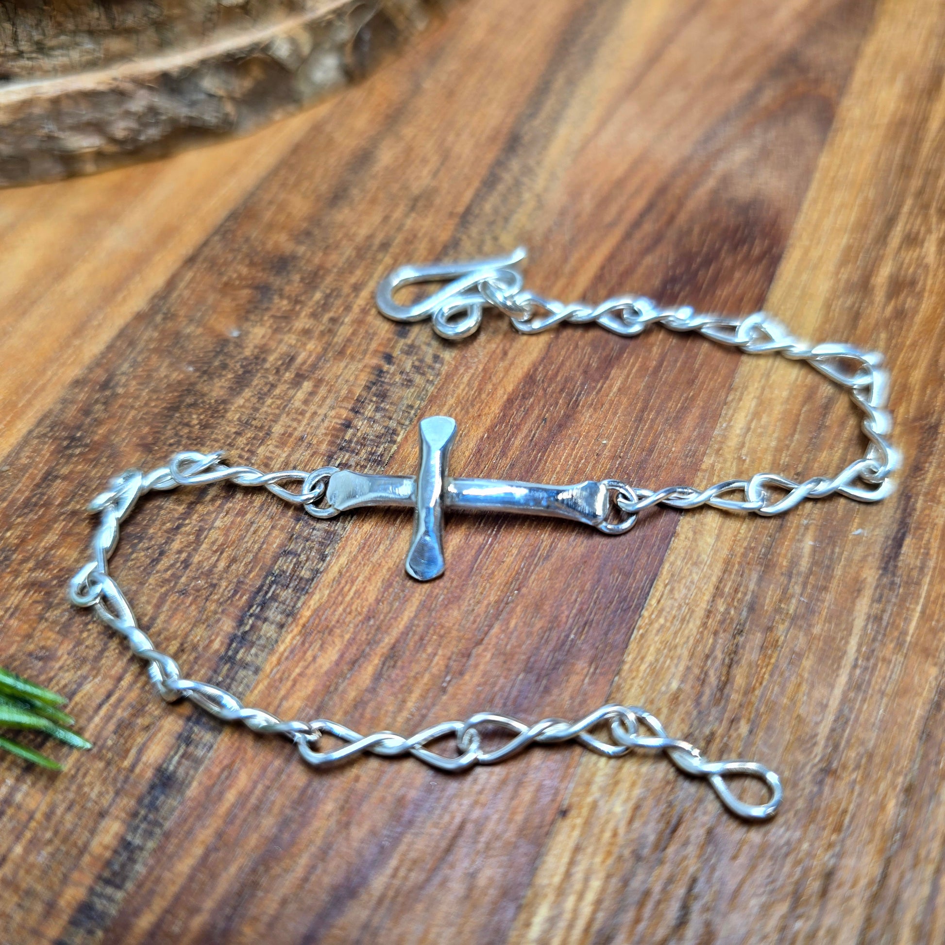 Hand-forged sterling silver cross bracelet with adjustable fit