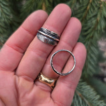Load image into Gallery viewer, Hand-forged sterling silver feather ring displayed on hand
