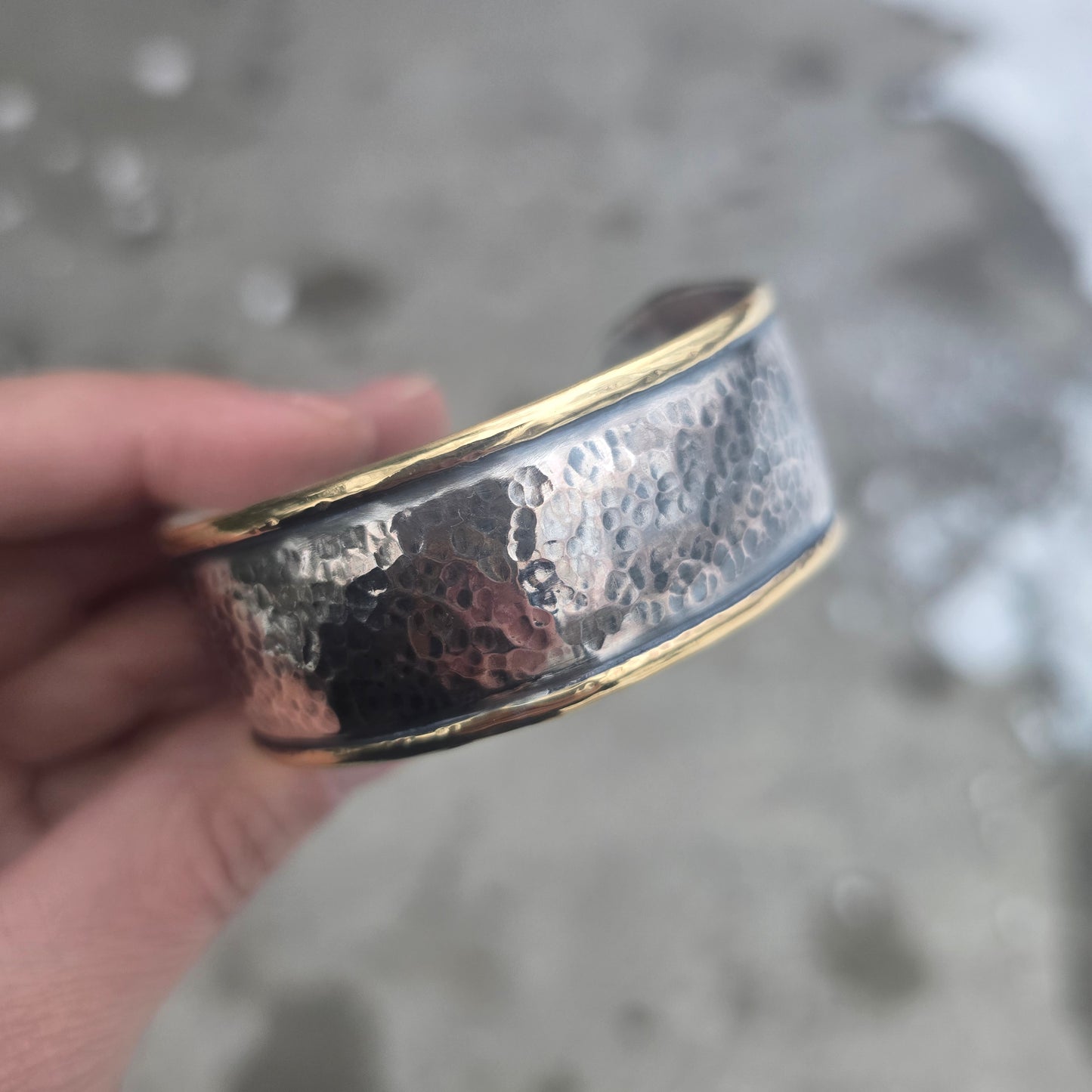 Sterling silver hammered cuff with brass perimeter side view