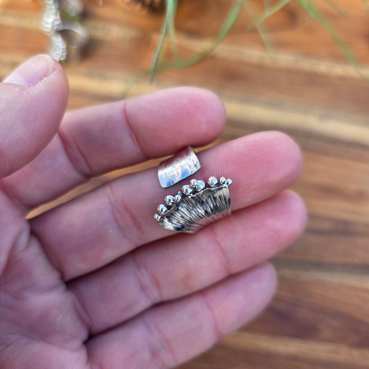 Sterling silver pearl ridge adjustable ring displayed on finger top view