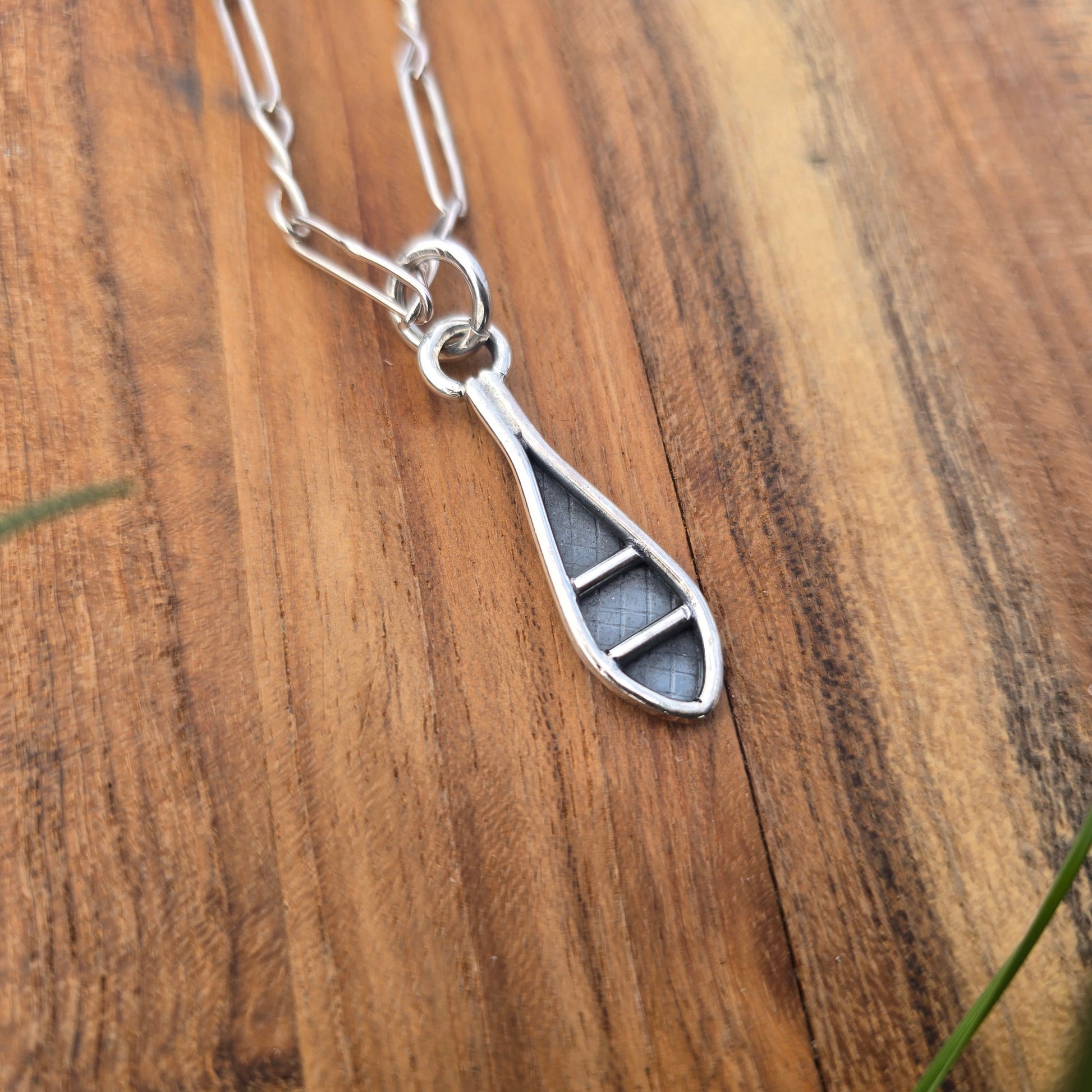 silver snowshoe pendant angled view
