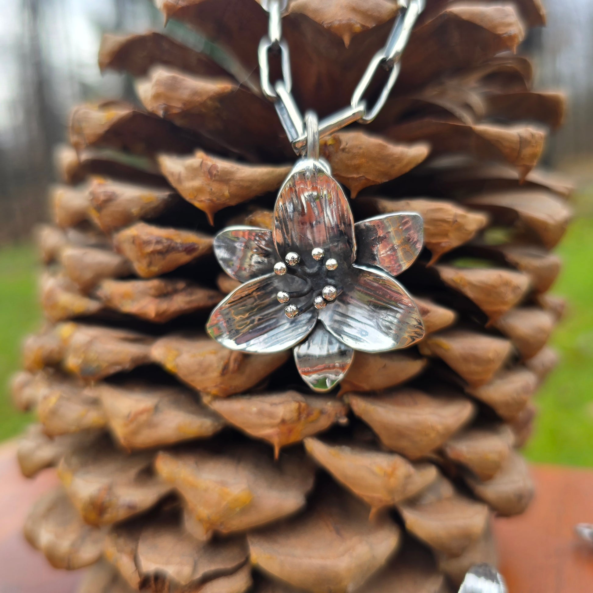 handforged sterling silver trillium pendant shown on chain