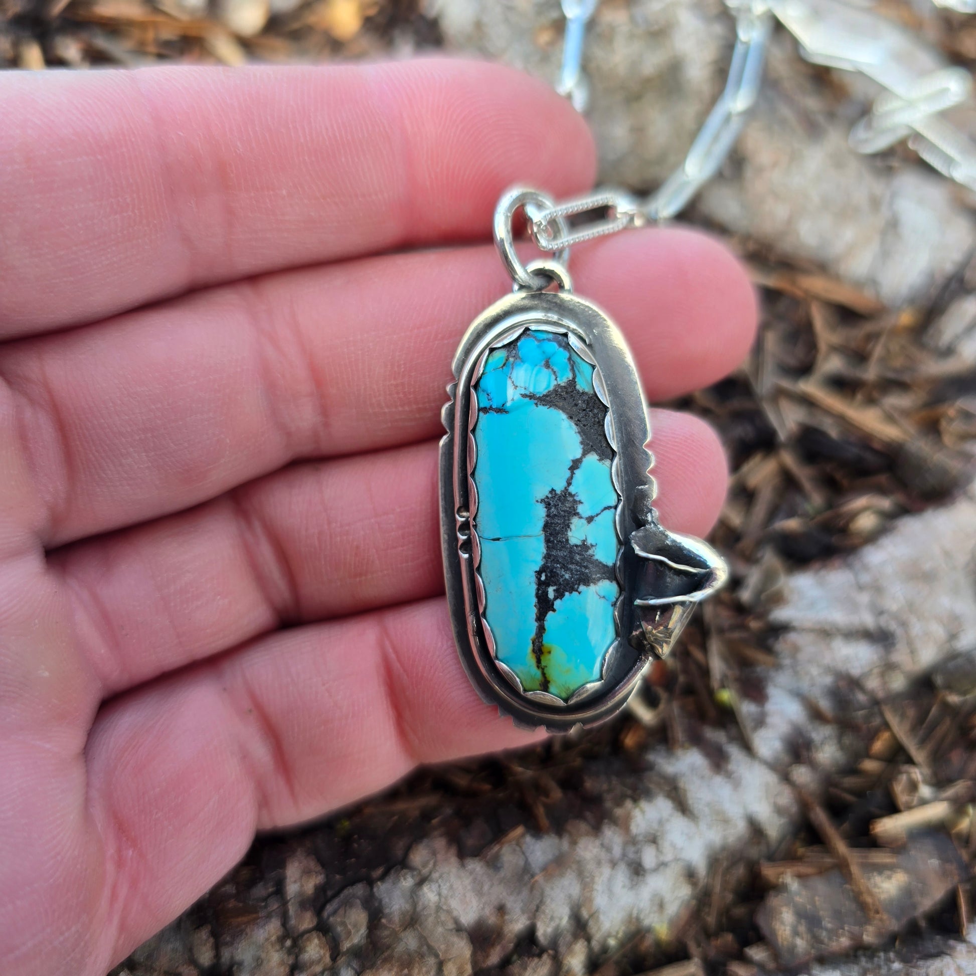 turquoise and calla lily pendant on hand