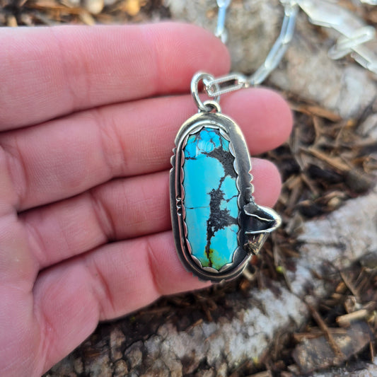 turquoise and calla lily pendant on hand