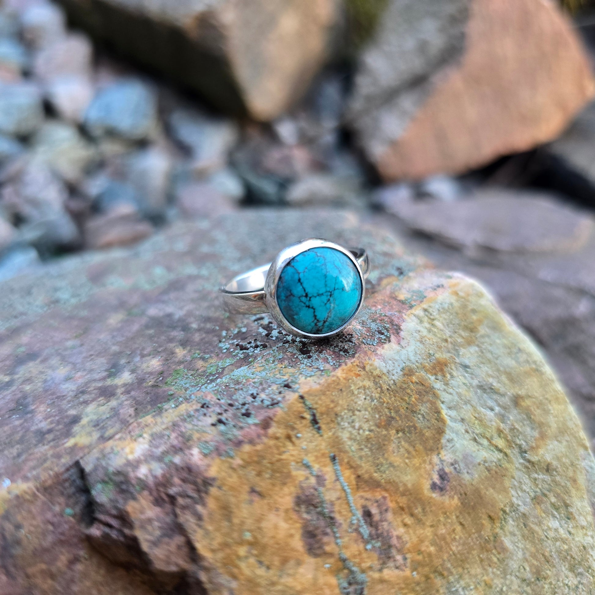 front view of turquoise ring with minimal bezel and simple sterling silver band