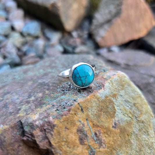 front view of turquoise ring with minimal bezel and simple sterling silver band