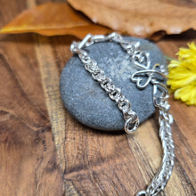 Load image into Gallery viewer, Sterling silver chainlink bracelet with high polish finish and twisted heart cross link, handmade by Sterling Roots in the Adirondacks.
