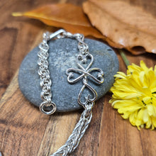 Load image into Gallery viewer,  Artisan sterling silver chainlink bracelet forged by hand in Northern New York, featuring a twisted heart cross centerpiece.
