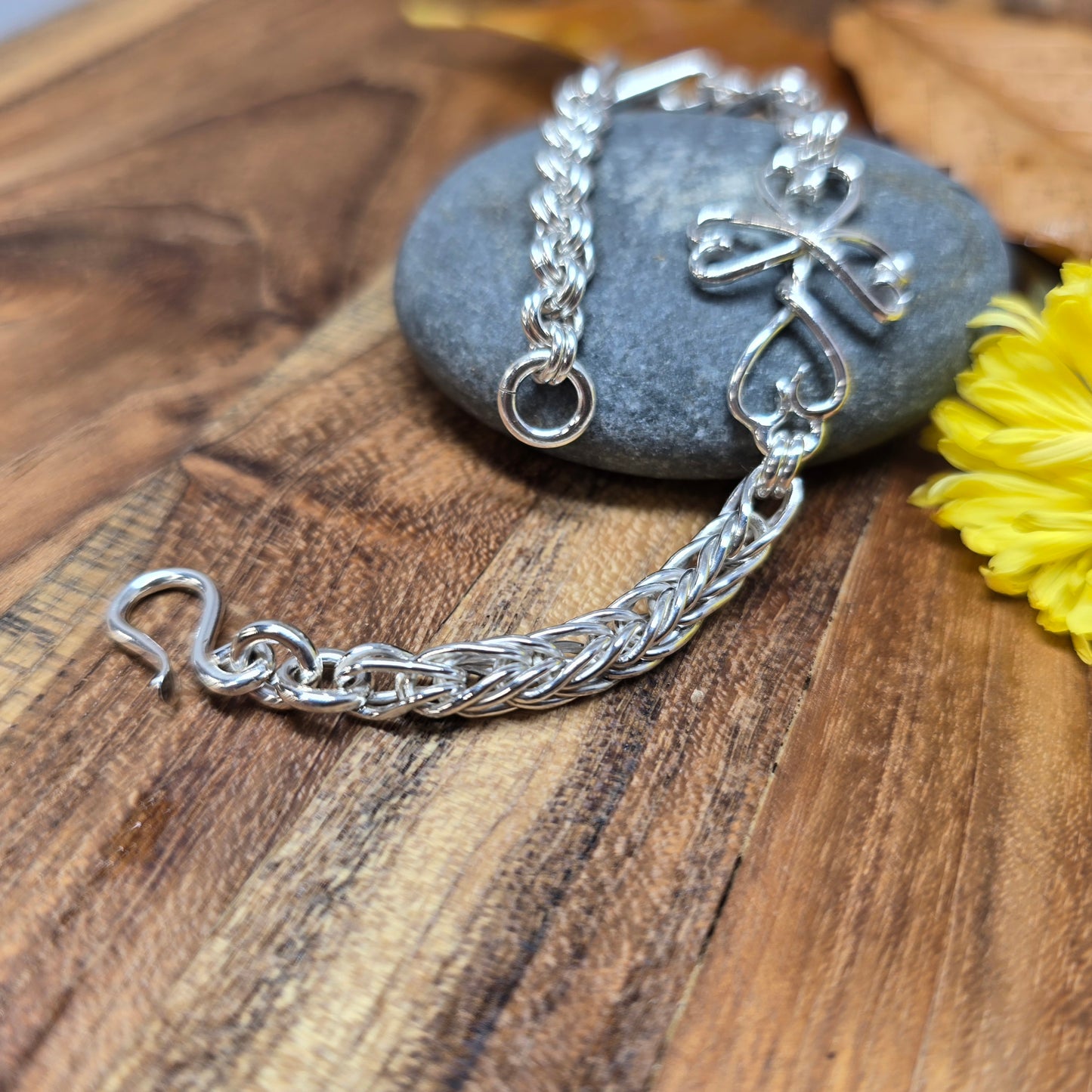 Hand-forged sterling silver chainlink bracelet with Twisted Heart Cross link, crafted in Northern New York by Sterling Roots.