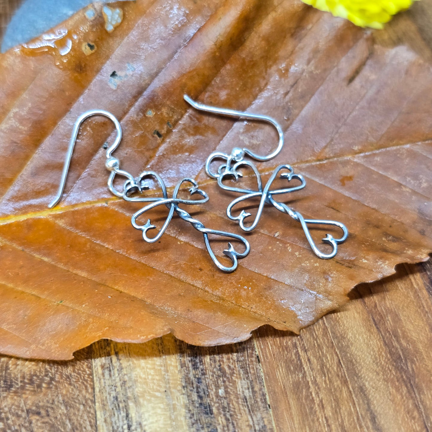 Dainty hand-forged Twisted Heart Cross earrings in sterling silver, built in Northern New York by Sterling Roots.
