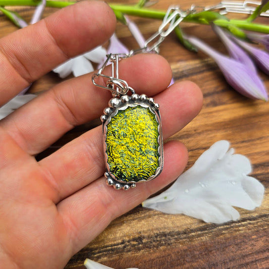 Sterling silver and yellow pendant with beads on hand