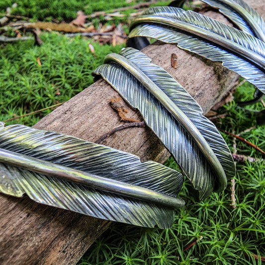Detail of hand-forged feather cuff bracelets
